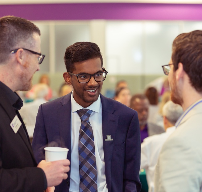 Three males talking in a group